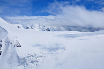 Clouds above the snowy mountains near Zermatt.