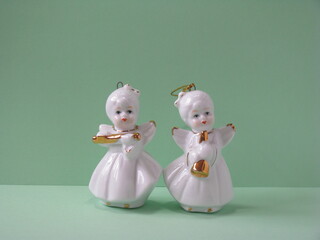 Ceramic figurines of two angels. Little angels with musical instruments.