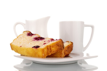 Two slices of homemade cottage cheese casserole with cherries on a ceramic saucer next to a ceramic cup and milk jug, macro, isolated on a white background.

