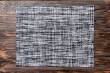 Top view of grey tablecloth for food on wooden background. Empty space for your design