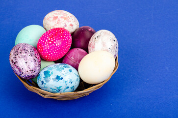 Decorated handmade Easter eggs for the holiday season on blue background. Creative minimal abstract concept. Studio Photo