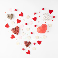 Valentine's Day.love creative pattern made of neatly arranged different heart sizes in the shape of one big heart on white background. Flat lay.