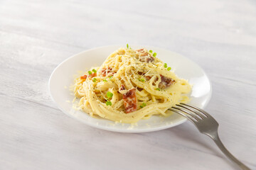 food,pasta carbonara with bacon on a white wooden table ,selective focus
