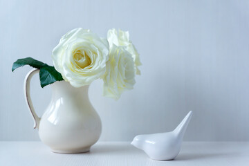 Delicate white roses on a light background and different decor.