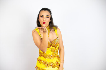 Young beautiful woman wearing carnival costume over isolated white background looking at the camera blowing a kiss with hand on air being lovely and sexy. Love expression.