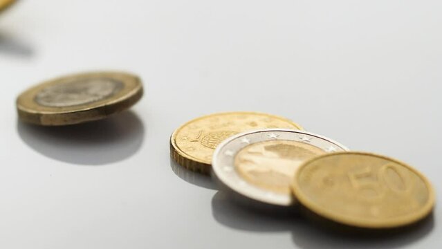 Euro coins falling on the ground - slow motion