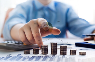 A man's hand shows a financial graph or chart. Financial profit and income. Savings and growth of capital and money