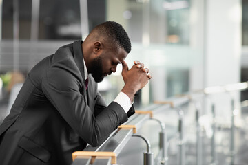 Overwhelmed black businessman feeling down after business meeting