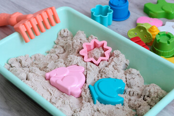 Light kinetic sand and figures. The child sculpts figures from bright details, animals. Educational game material for the early growth of the baby. Hand motor skills, 