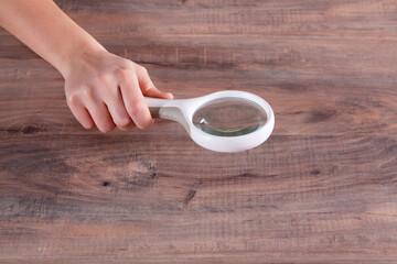 young woman holding a magnifying glass