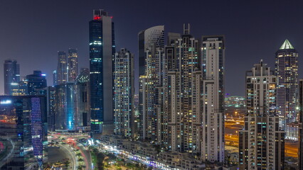 Bay Avenue with modern towers residential development in Business Bay aerial all night timelapse, Dubai
