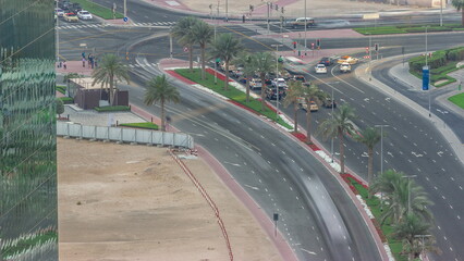 Aerial top view of city traffic on a crossroad in Dubai Business bay timelapse.