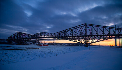 Quebec bridge at sun set in winter time