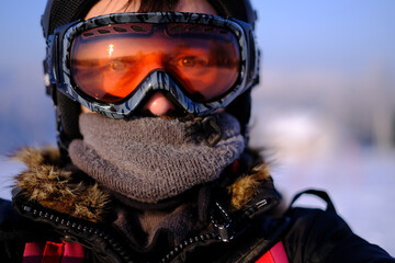 skier in helmet and goggles looking directly at camera
