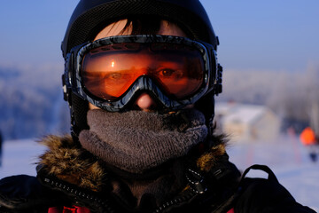 skier in helmet and goggles looking directly at camera
