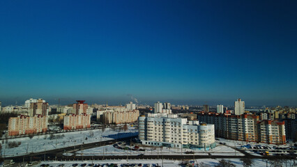Fototapeta na wymiar City block. Modern multi-storey buildings. Winter cityscape. Aerial photography.