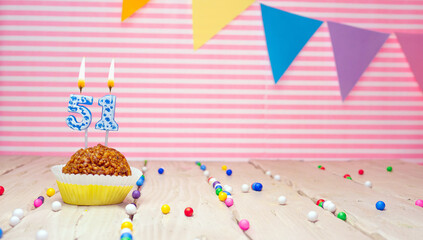 Happy birthday to 51 years old. Festive background with muffin. Copy space birthday card for fifty...