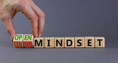 Open or closed mindset symbol. Businessman turns wooden cubes and changes concept words closed mindset to open mindset. Beautiful grey background, copy space. Business open or closed mindset concept.