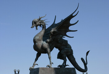 Fototapeta premium Kazan, Russia - July 13, 2021: Statues of Dragon Zilant at Kazan Wedding Palace (Family Center) at sunset, Tatarstan. It is landmark of Kazan. 
