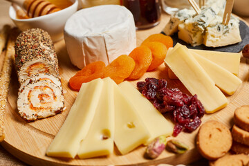 Platter of cheeses, fruit, jams
