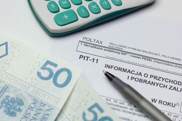Closeup of PIT-11 tax form – information on income and income tax withholdings.

