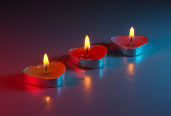 burning colored scented heart shaped candles