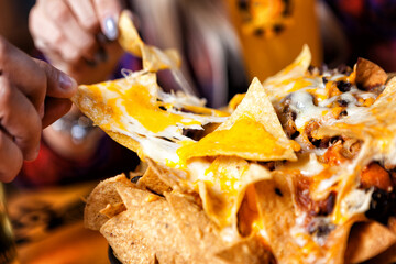 Hands on tasty nachos - obrazy, fototapety, plakaty