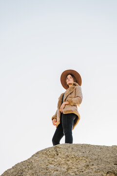 Traveling woman standing on cliff