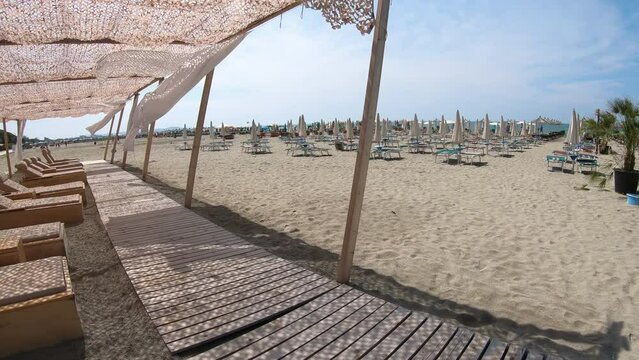 Suumer vacation luxury resort white tent on a sandy beach against the background of blue sunny sky