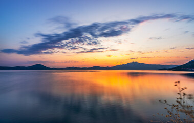 Spectacular sunset view of Lake Bafa in Turkey. Clouds reflect in the Lake Bafa Nature Park at sunset.