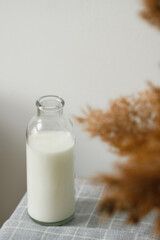 Vintage glass milk bottle on the table. Rustic style