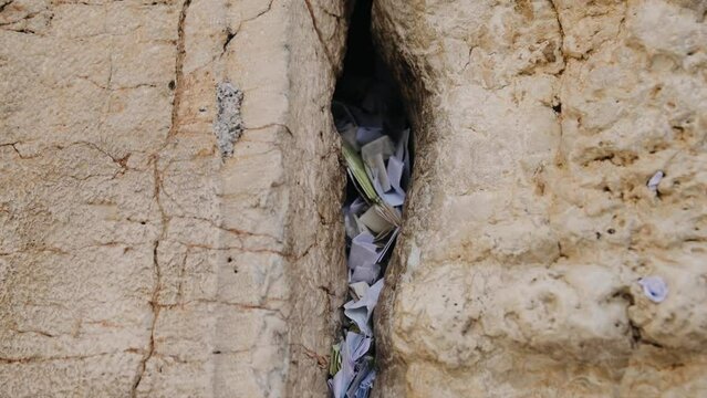 Footage of wish notes in the cracks of Western Wall (Kotel) Jerusalem. Israel. Dynamic video. Steadicam shot