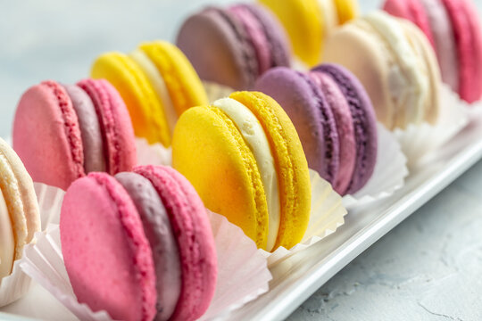 pink macaron or macaroon cakes with peony rose on a white background. Banner, flyer, beautiful postcard, top view - Powered by Adobe