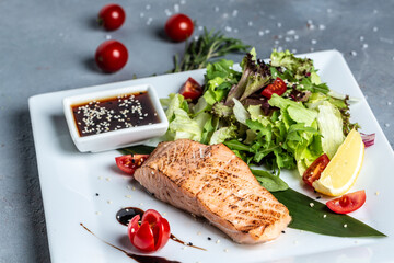 Grilled Salmon fish steak with fresh vegetables salad, Healthy salad for keto diet, friendly salmon with vegetables diet dish. Paleo, keto Diet