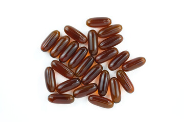 Sunflower lecithin in capsules on a white background. Lecithin in brown capsules top view. Food supplements close-up.