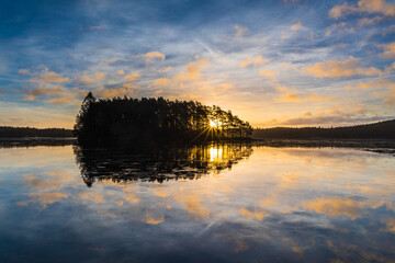Reflection on icy lake at sunrise