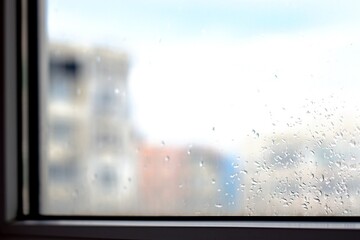 Rainy evening. Drops are like tears on glass.