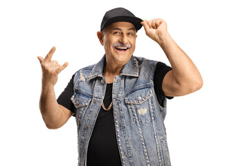 Smiling trendy mature man holding his cap and gesturing a rock and roll sign