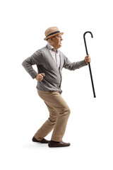 Happy elderly man with a walking cane dancing