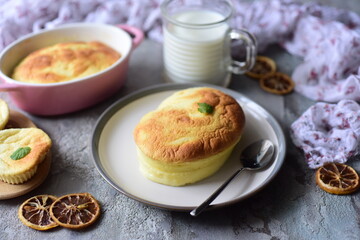 Breakfast for the family: lemon souffle on a beautiful plate on a gray background. Close-up