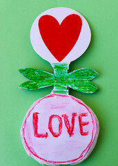 paper craft red heart in a drop-down flower written word love in pencil