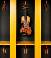 Violin on a yellow and black shelf
