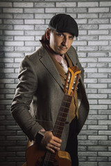 Vintage guy playing acoustic guitar and singing on retro wallpaper