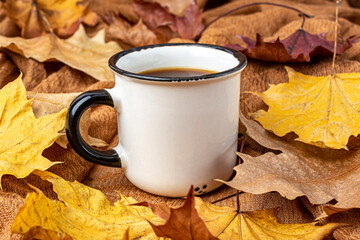 cup of coffee on the background of yellow maple leaves