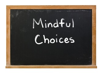 Mindful choices written in white chalk on a black chalkboard isolated on white