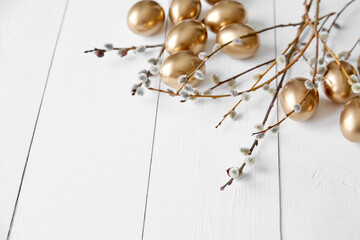 Easter eggs with pussy willow on white wooden table happy holiday background