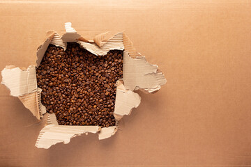 Coffee beans in torn cardboard paper. Coffee bean backround