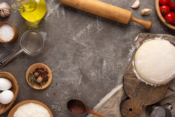 Pizza homemade cooking or baking at table. Dough pizza on slate background