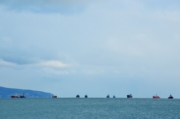 Seagoing ships along the horizon line of the Black Sea coast, Novorossiysk.