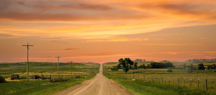 a county gravel road runs through farm land in north eastern Colorado east of Sterling